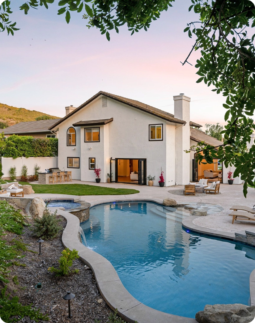 House with pool and outdoor seating area.