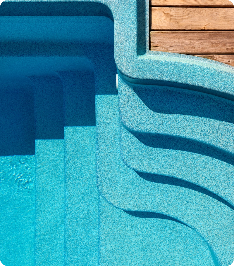Swimming pool steps with wooden deck.